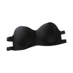 Black breathable fashion bandeau bra with adjustable straps laid flat on white surface with Paris-themed papers