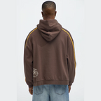 Back view of man wearing brown graphic hoodie for men with yellow stripes on sleeves by VacationGrabs
