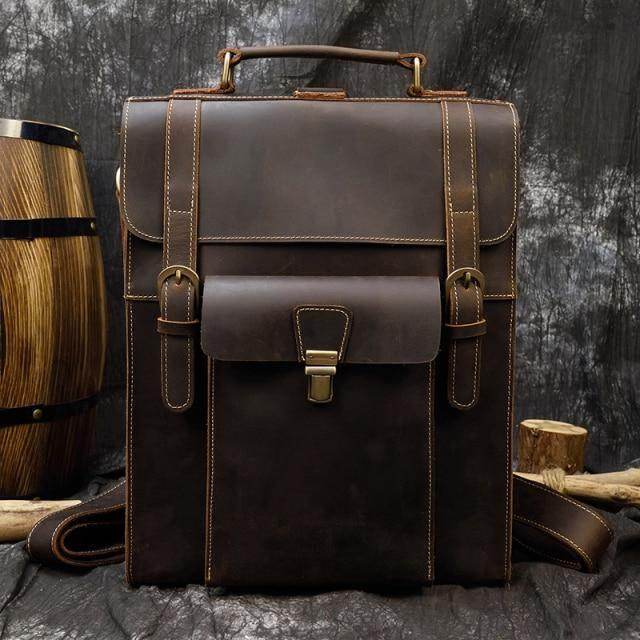 Brown leather laptop backpack with vintage design and sturdy handle for everyday use