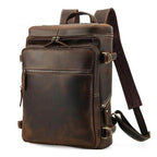 Brown leather laptop backpack with multiple compartments and adjustable straps for travel