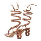 Brown strappy high heel sandals with unique geometric heels by Rag Company