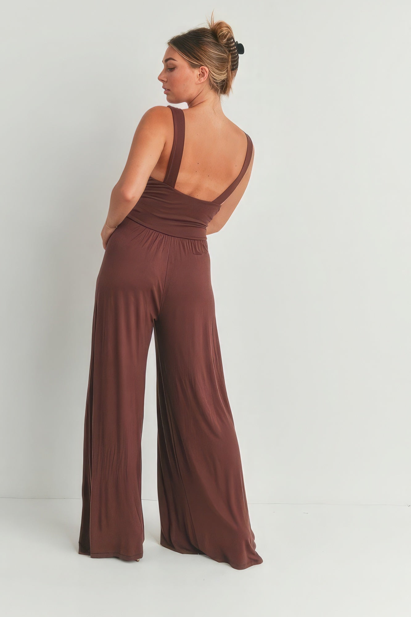 Back view of brown wide leg romper with a flattering fit and elegant design for women