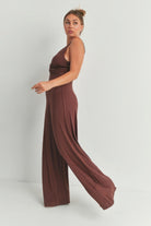 Elegant brown wide leg romper with a flattering twist design, perfect for casual outings