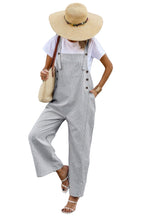 Stylish women's button trim casual jumpsuit in gray with wide legs and oversized hat for summer outings