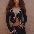 Black cable knit sweater with unique frill design for stylish layering