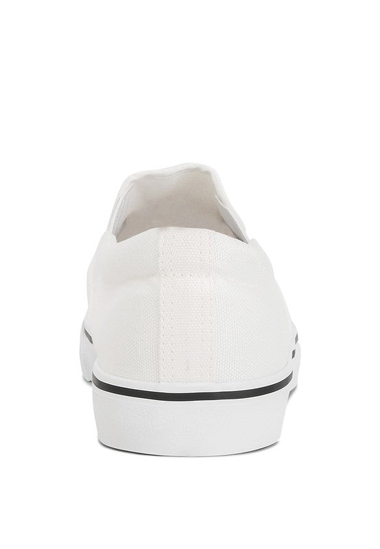 Rag Company white canvas slip on sneakers showing back view with black stripe on sole