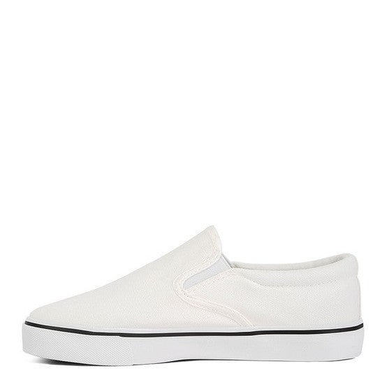 Rag Company white canvas slip on sneakers with black trim and rubber sole for women