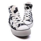 Trendy canvas sneakers with patterns in black and white cow print for women