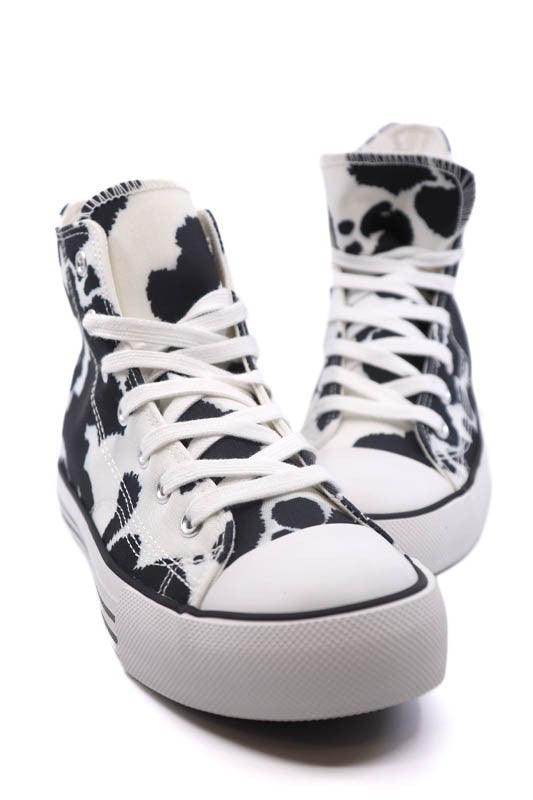 Trendy canvas sneakers with patterns in black and white cow print for women