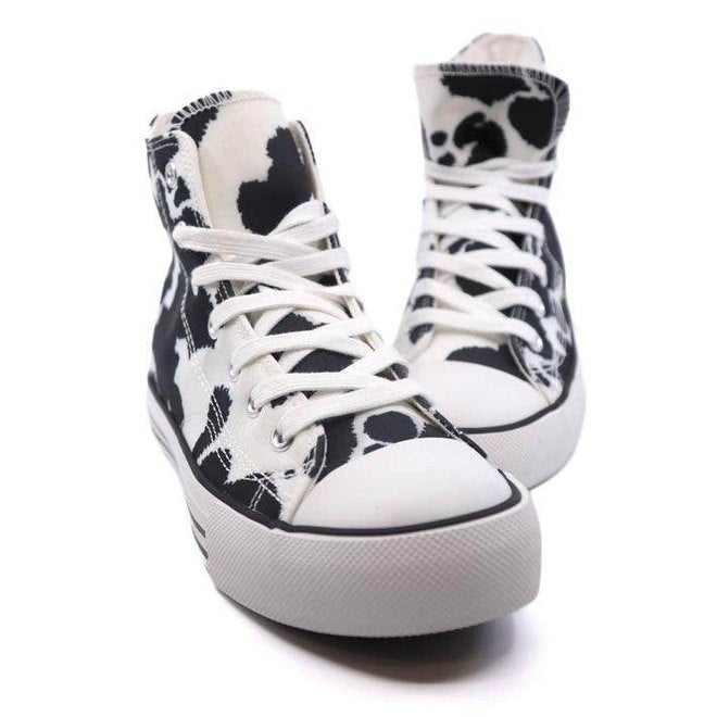 Trendy canvas sneakers with patterns in black and white cow print for women