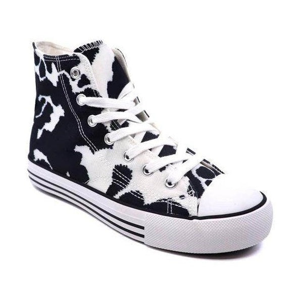 Women's canvas sneakers with patterns in black and white cow print design for casual wear