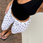 Women's capri dress pants in white with black polka dots for casual outings