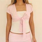 Women's pink cropped cardigan with a tie front, perfect for layering