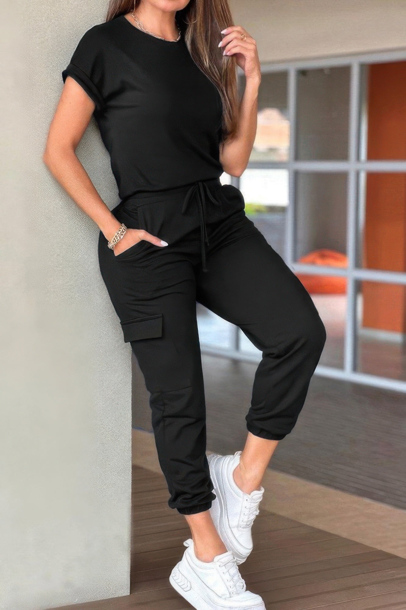 Casual crew neck short sleeve jumpsuit in black with drawstring waist and pockets, perfect for everyday wear