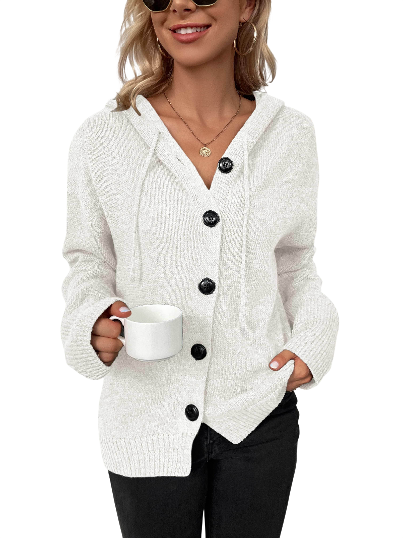 Woman wearing a white button-up cardigan holding a mug on a white background