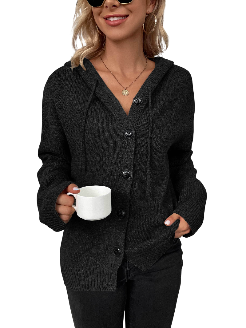 Woman wearing a dark gray cardigan holding a white mug on a white background