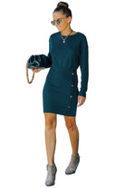 Woman wearing a casual long sleeve dress for travel in green with button details and stylish accessories