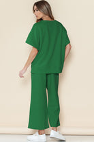 Woman wearing green casual matching sets for travel with loose top and wide-leg pants