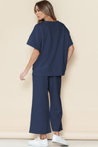 Woman wearing navy casual matching sets for travel with wide-leg pants and a loose top from SHEWIN INC