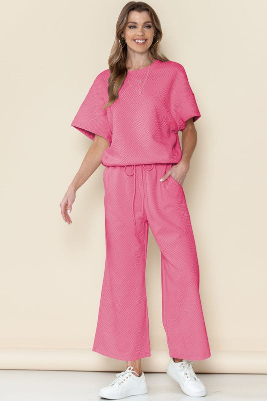 Pink casual matching sets for travel with short sleeve top and wide-leg pants worn with white sneakers