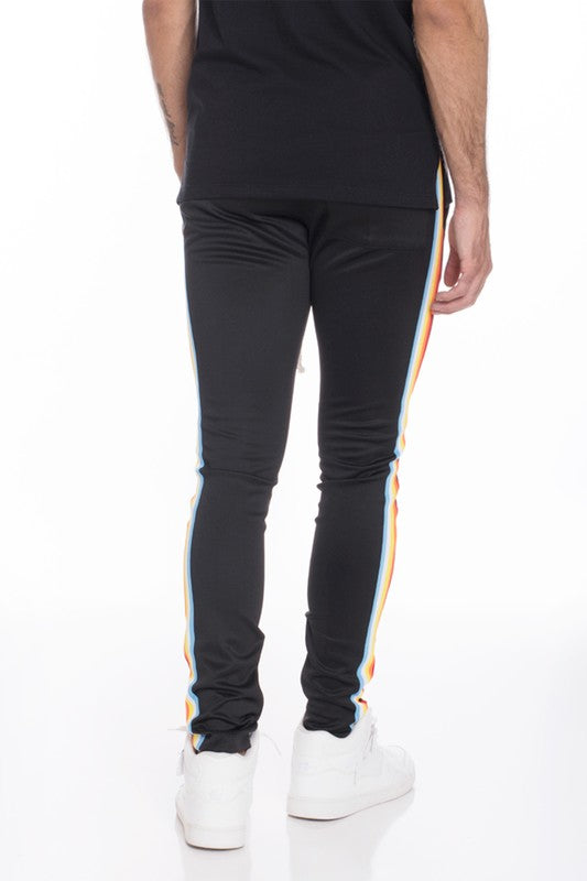 WEIV casual rainbow tape sweatpants in black with colorful side stripes worn by male model