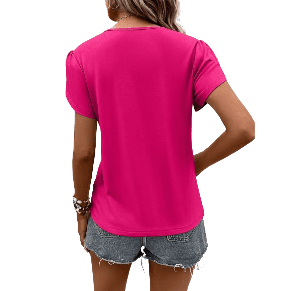 Back view of a pink women's casual v-neck vacation shirt styled with denim shorts