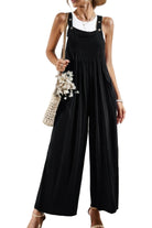 Casual vacation jumpsuit for women in black with wide legs and adjustable straps for a relaxed fit