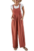 Casual vacation jumpsuit for women in rust color with wide legs and pockets, perfect for summer outings.