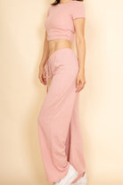Capella casual wide-leg pants outfit in soft pink with matching crop top and white sneakers