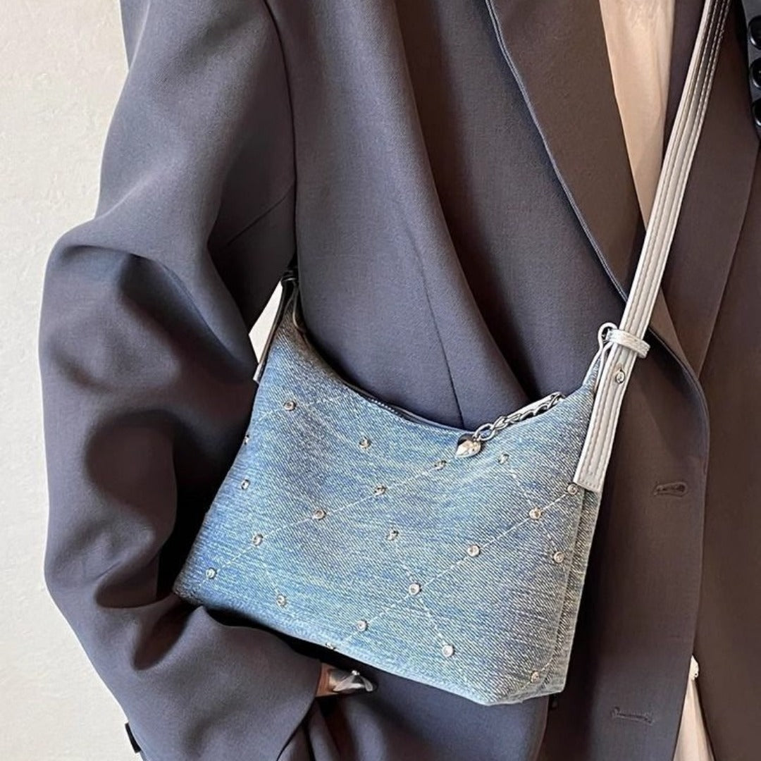 Chic denim hobo bag with silver studs, perfect for trendy casual outfits