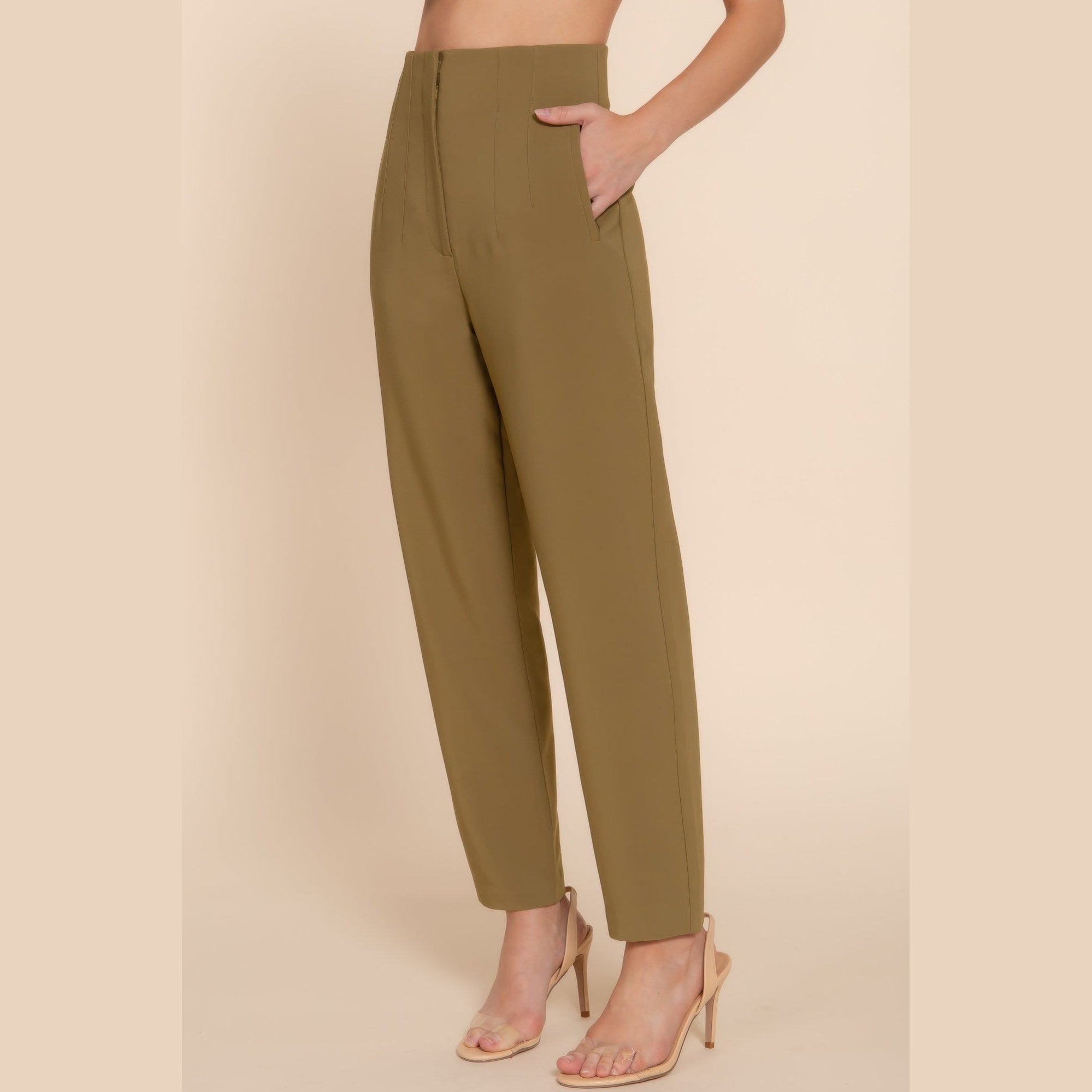 Chic high waisted dress pants for women in olive green styled with nude heels