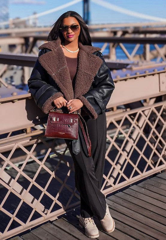 Rag Company chunky heel winter boots for women styled with a chic outfit on a bridge