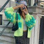 Green and yellow chunky knit blanket, cozy for outdoor lounging