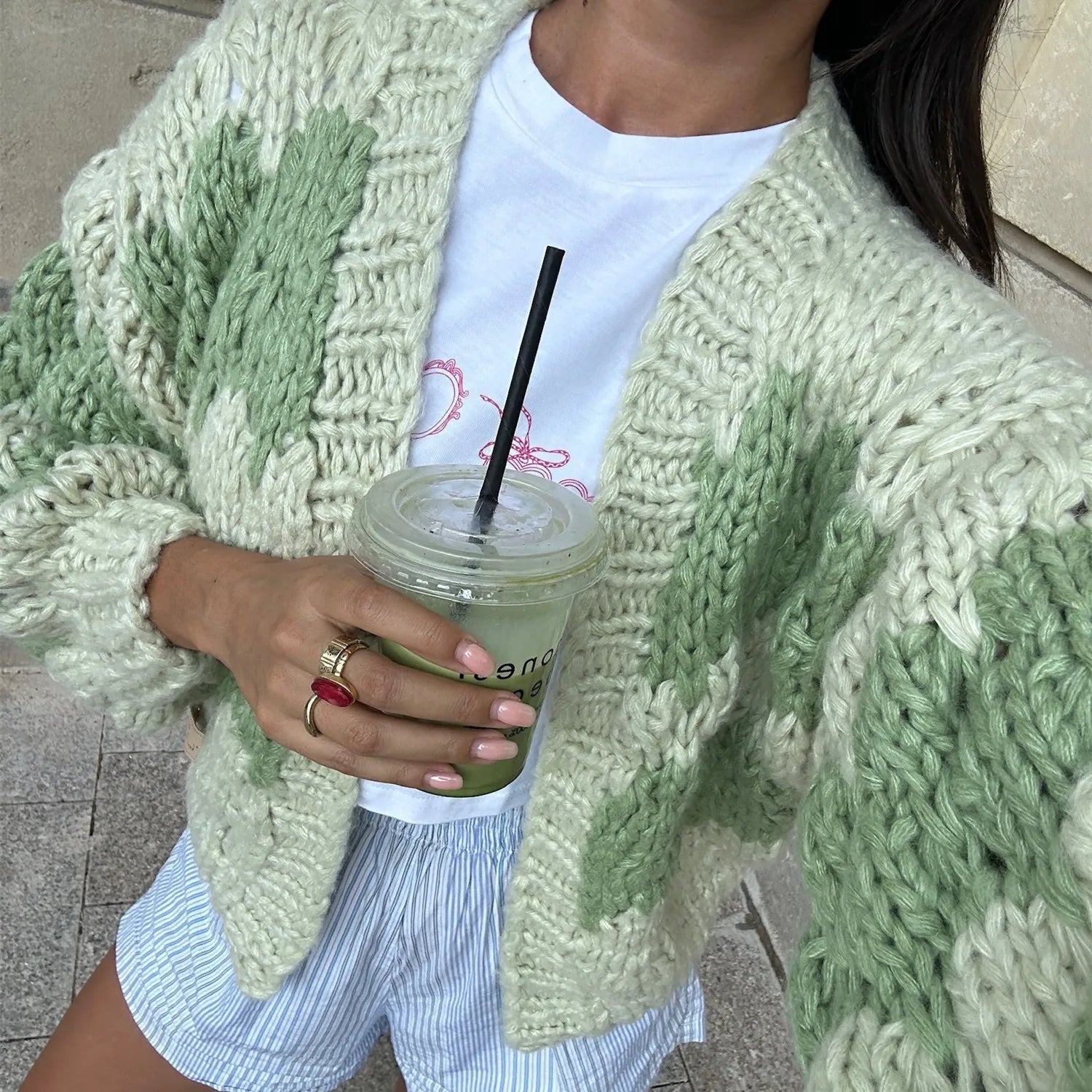 Chunky knit blankets in soft green for cozy lounging