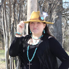 Chunky turquoise teardrop necklace worn by a model with matching accessories outdoors