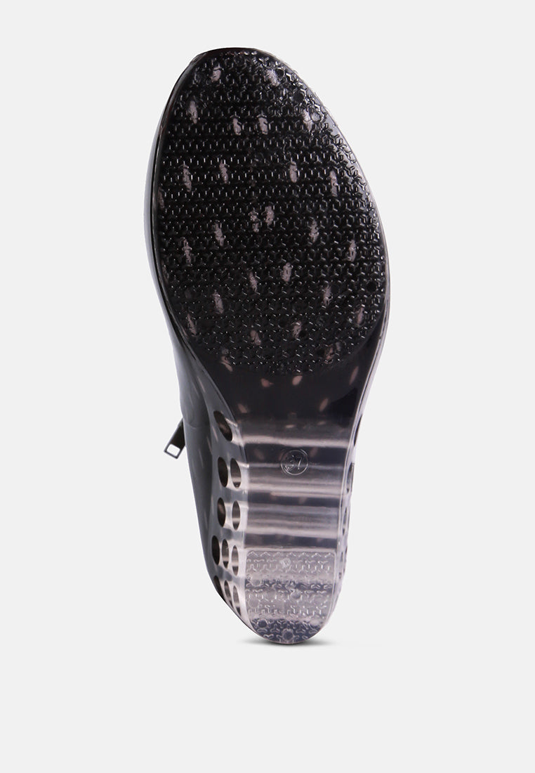 Clear wedge rain boots for women with a textured outsole for improved grip and stability