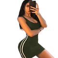 Woman wearing a green clubwear short dress for women with white stripes taking a mirror selfie