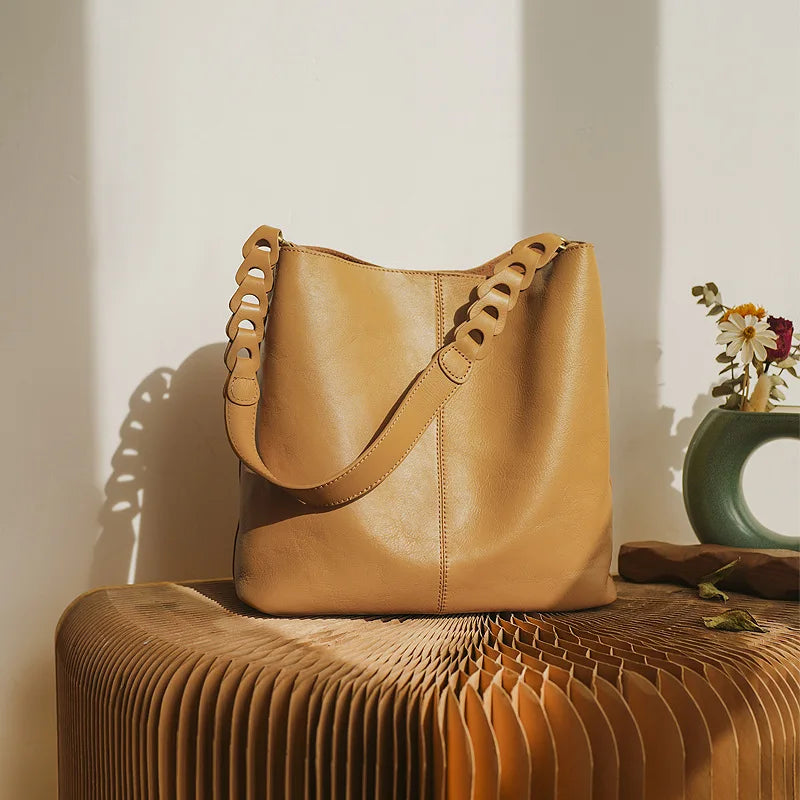 Tan leather coach purse shoulder bag with unique strap design