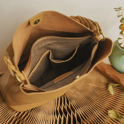 Tan leather coach purse shoulder bag with spacious interior and elegant design