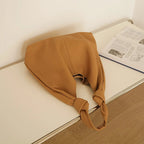Tan coach purse shoulder bag made of soft fabric for casual use
