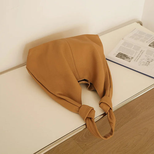 Tan coach purse shoulder bag made of soft fabric for casual use