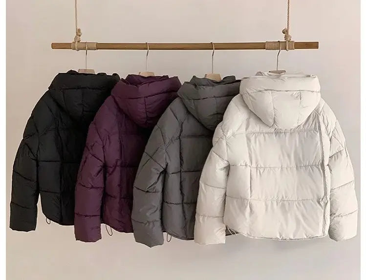 Women's puffer coat in black, purple, gray, and white for winter warmth