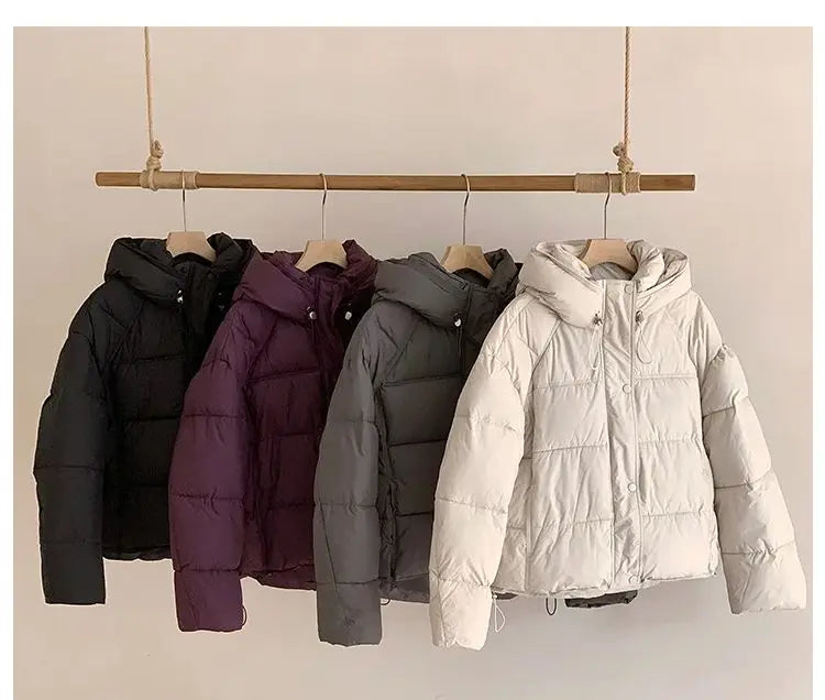 Women's puffer coat in black, purple, gray, and white for winter warmth