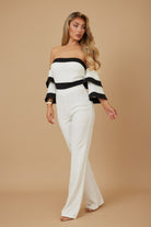 Elegant color block formal jumpsuit featuring off-the-shoulder design and bell sleeves