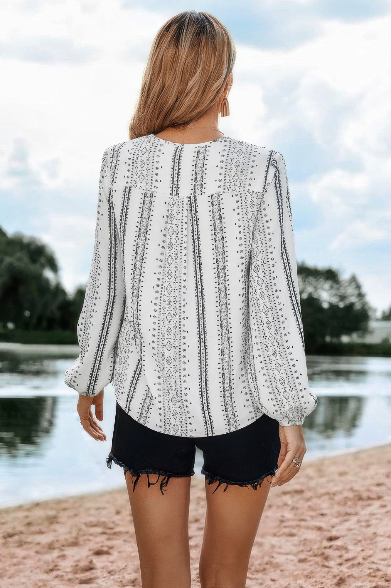 Back view of a Women's color block v neck ruffle blouse from VacationGrabs, paired with casual shorts