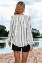 Back view of a Women's color block v neck ruffle blouse from VacationGrabs, paired with casual shorts