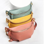 Colorful leather fanny packs in teal, yellow, and pink for stylish and convenient storage