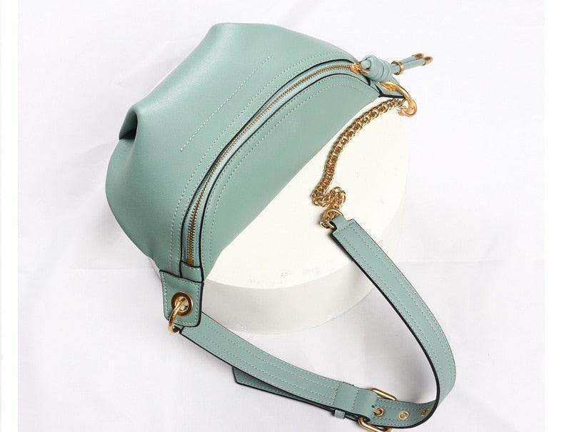 Stylish mint green leather fanny pack from VacationGrabs with gold chain strap and zipper closure
