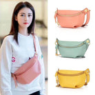 Colorful leather fanny packs in pink, mint, and yellow displayed on model for stylish travel convenience
