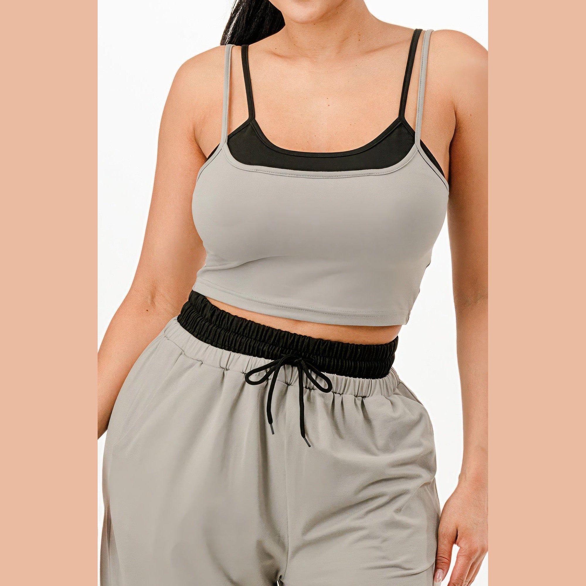 Women's comfortable matching loungewear set featuring a cropped tank top and elastic waist pants